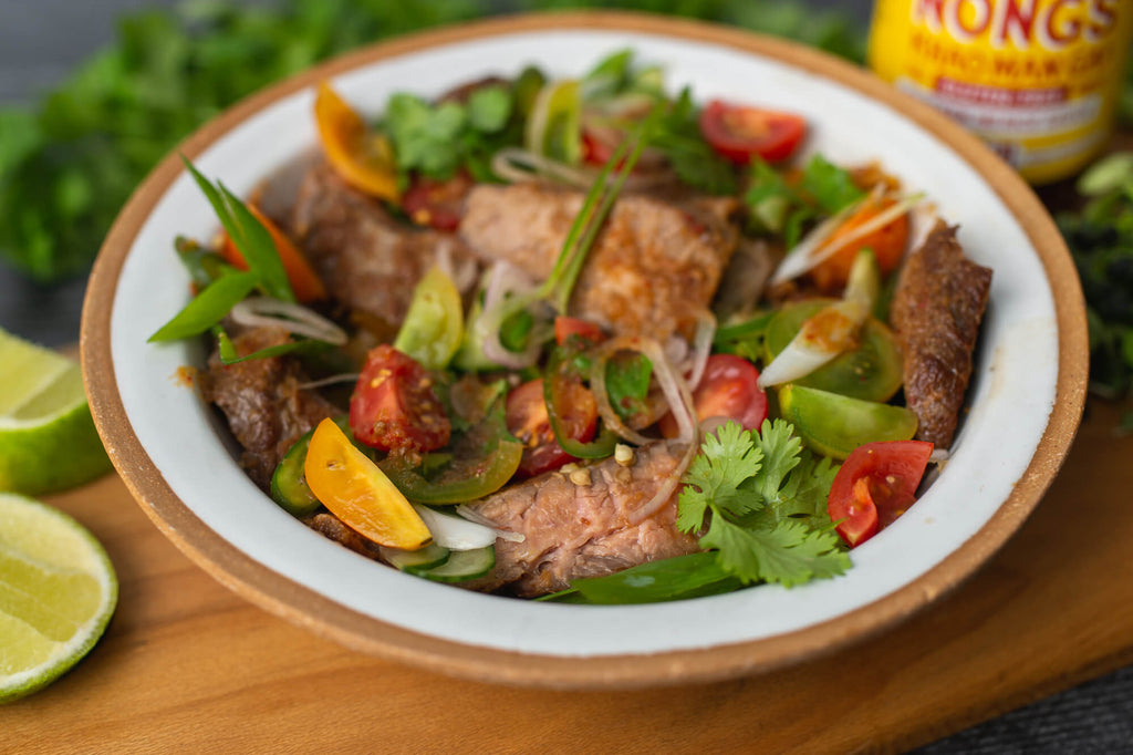 Thai beef salad with Nong's gluten free sauce in the background.