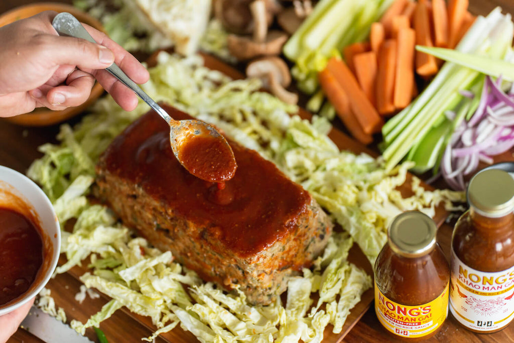Glazing turkey meatloaf with Nong's sauce.