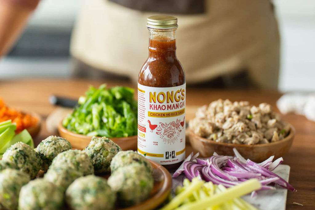 Nong's sauce pictured with uncooked meatballs.