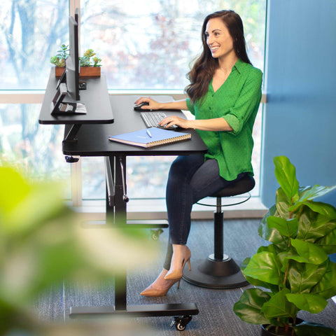 Alternate between sitting and standing with a height-adjustable desk for a more active, ergonomic workday.