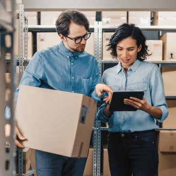 Using a tablet to count inventory in a warehouse.