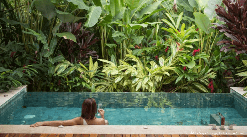Girl in a pool located in the jungle of Costa Rica