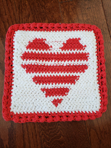 red white crocheted heart heat pad