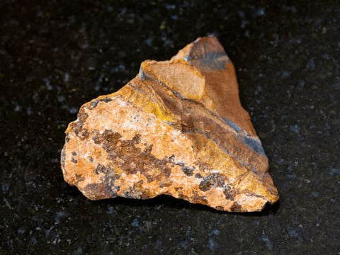 A mesmerizing Tiger's Eye stone, featuring golden-brown bands and a chatoyant shimmer, representing confidence, protection, and the balance of yin-yang energies.