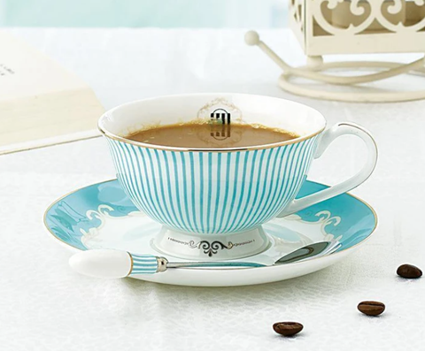 Teacups | White bone china teacup with blue stripes on a matching saucer.