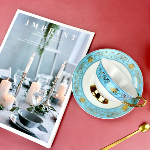 Teaware | Bone china teacup and saucer next to an interior magazine.