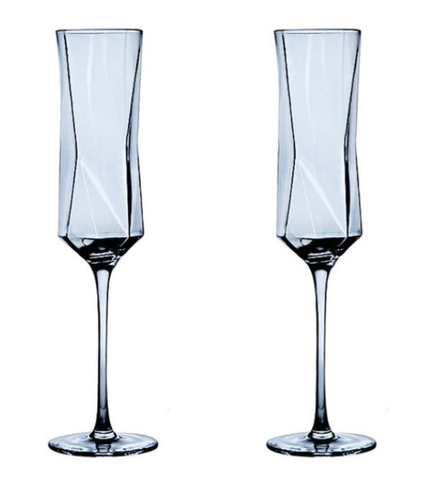 Champagne Glasses | Two crystal champagne glasses next to each other.