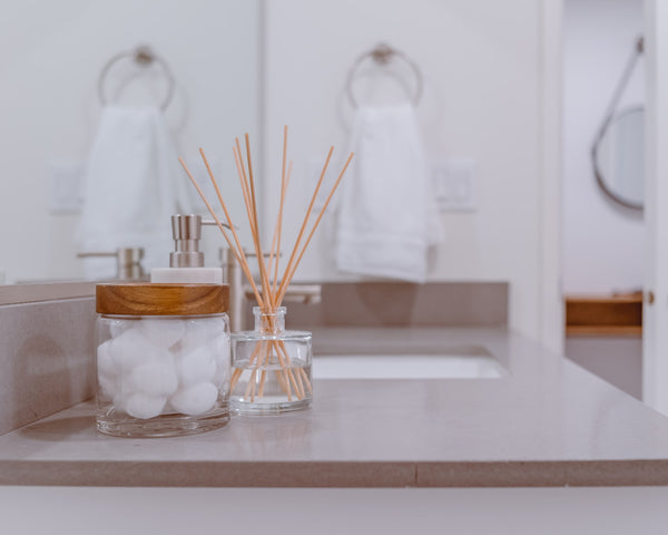 aroma reed diffusers on a bathroom sink