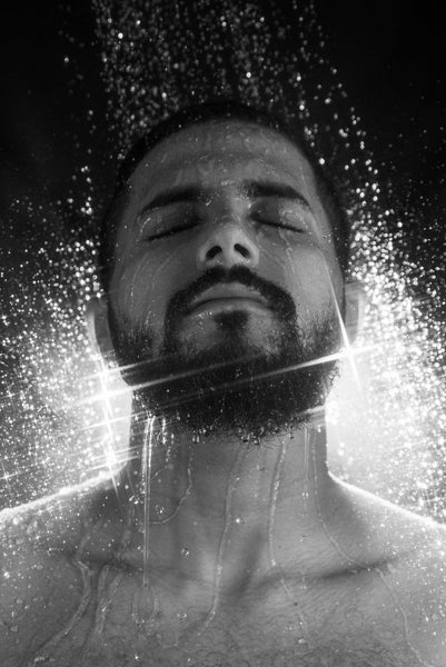 close up photo of bearded man taking a shower 