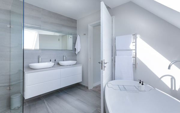 bathroom with white bathroom fixtures and white tiles