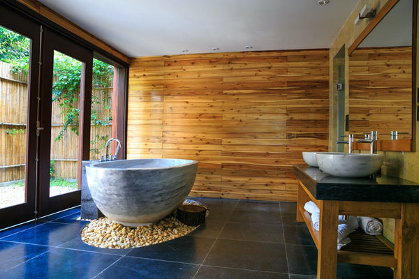 bathroom with bathtub and wooden walls