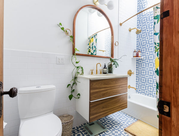 white bathroom with creeping plants near the floating sink 