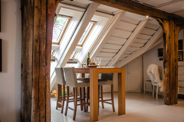 wooden beams in white walled attic room