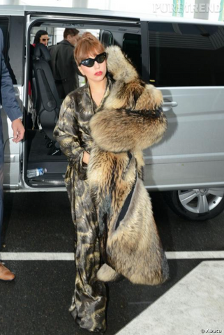 Lady Gaga in fur coat and sunglassess. Lady Gaga in brown suit and brown two piece