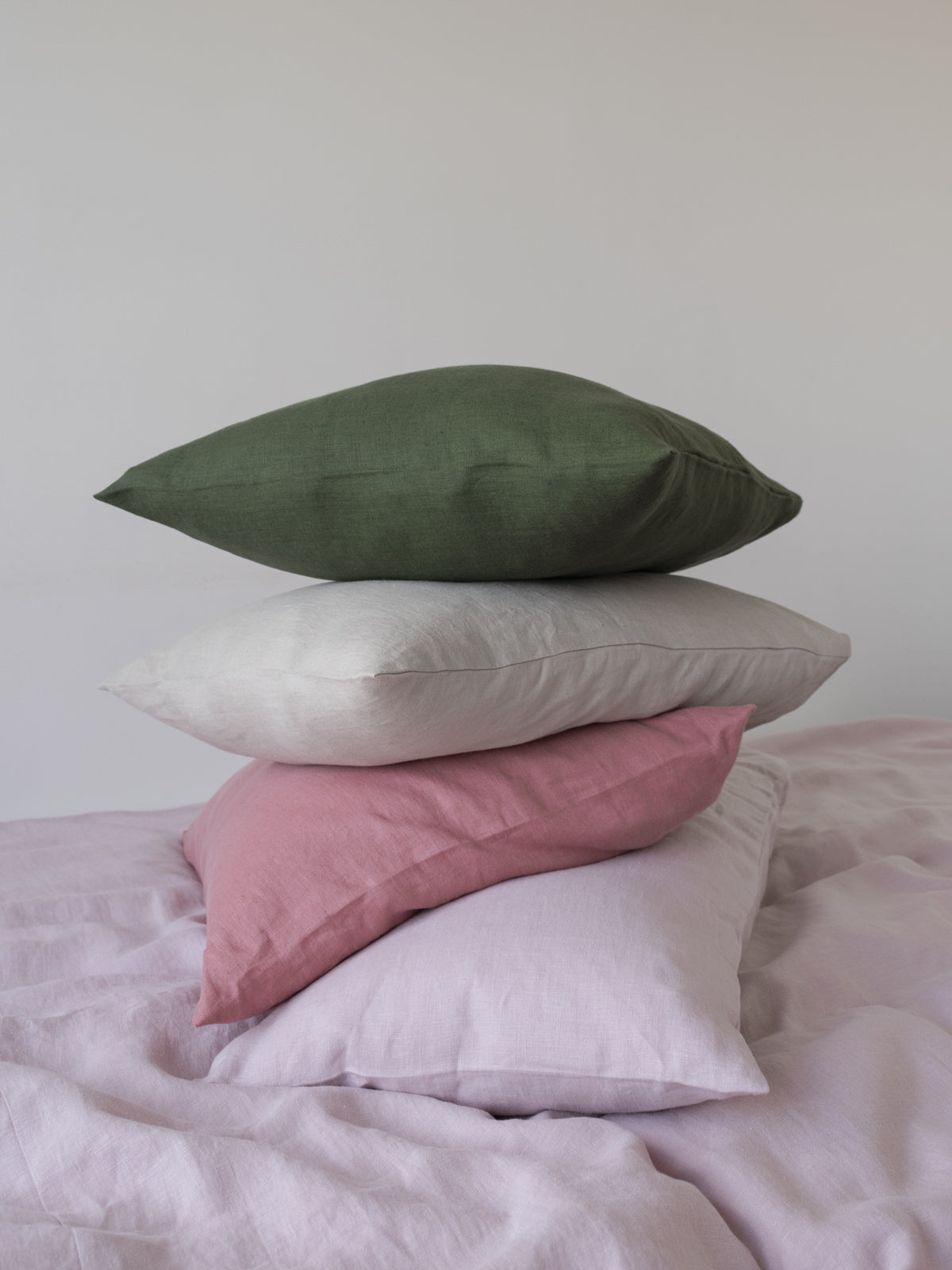 Linen bedding sheets in forest green, sand dunes beige and sky light blue sustainable and ethically made in the eu