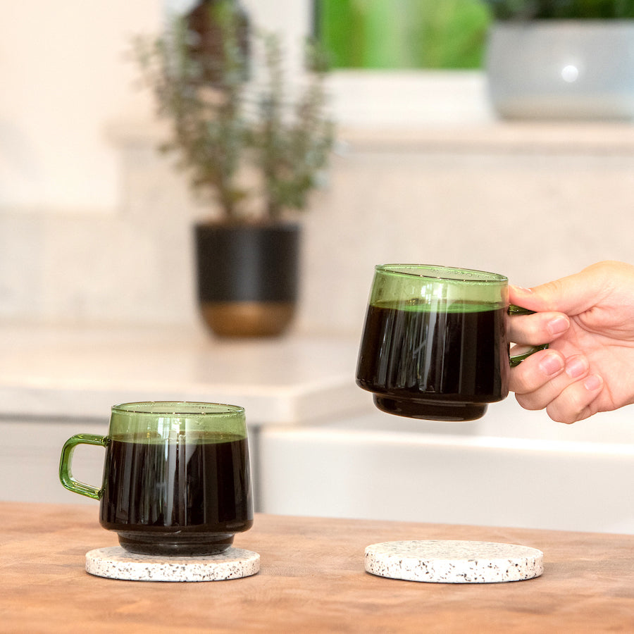 An amber glass v60 coffee dripper by Ordinary Better