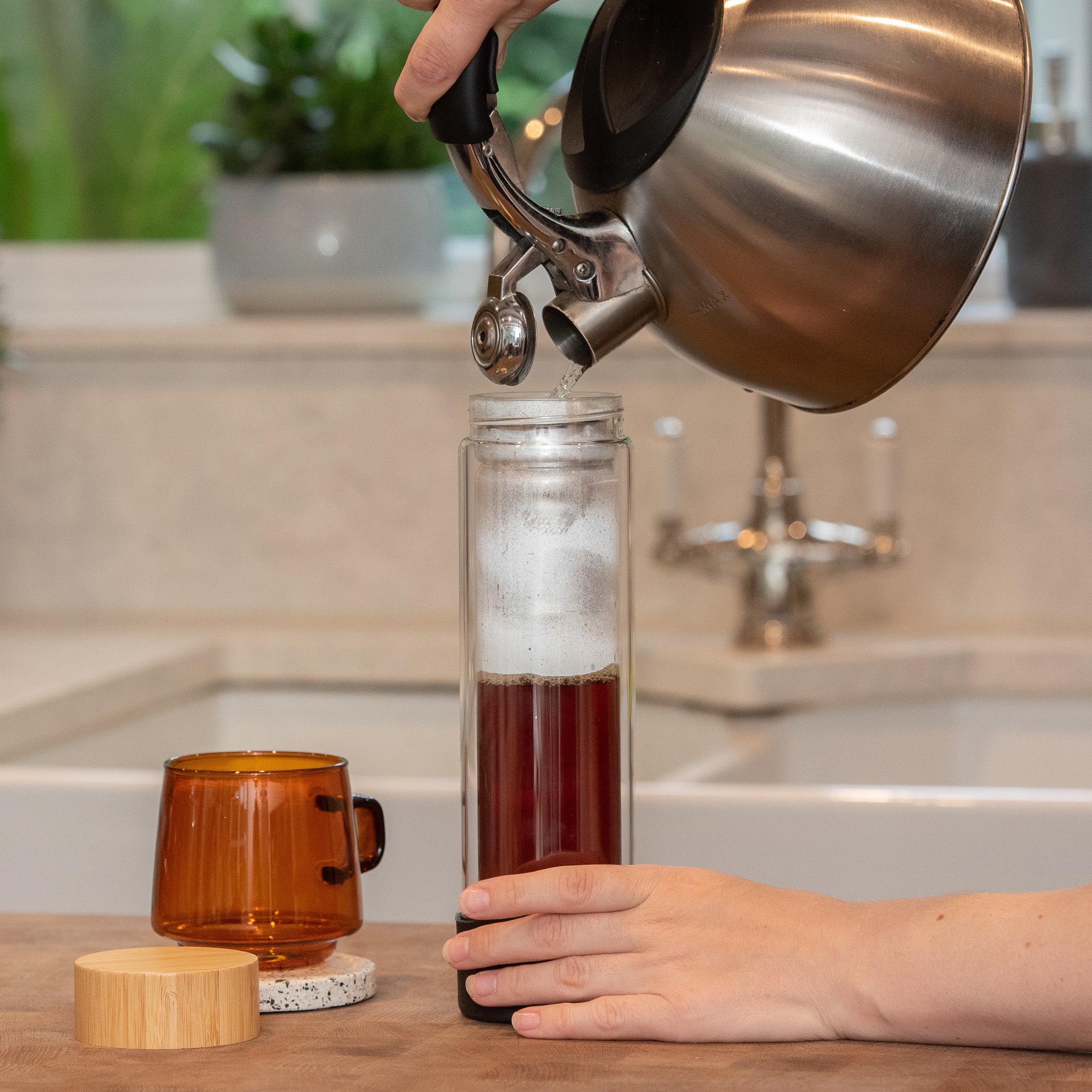 Pouring coffee into a coffee dripper by Ordinary Better