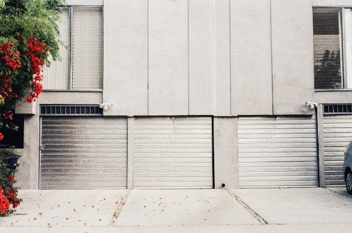 Grey roll-up doors in front of a grey building