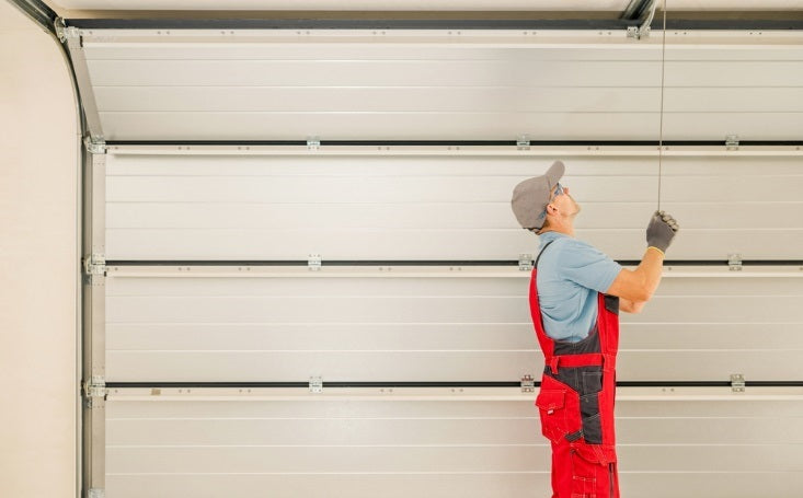 Man pulling a string from the ceiling near garage door