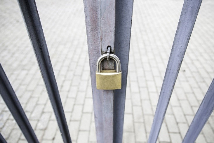 Padlock on security gate