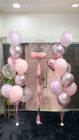 pink white and silver balloon floor bouquets with clear bubble balloon and tassel