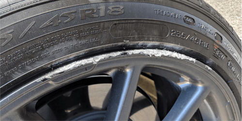 Tesla wheel rim with curb rash