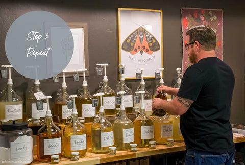 refill bar with gallon glass containers a man pumping dish soap into an amber bottle