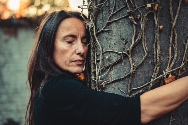 woman hugging tree