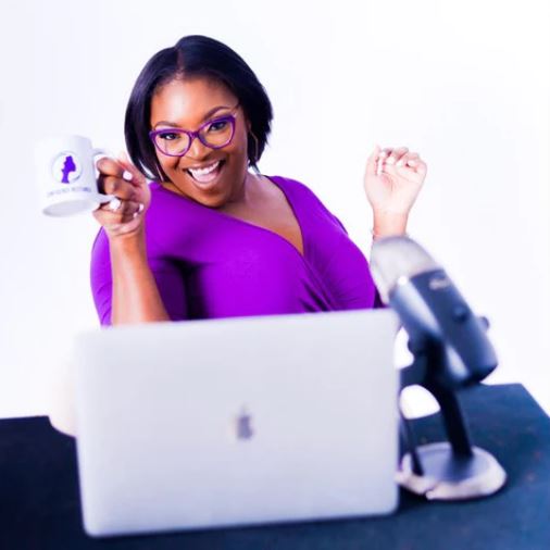 Image of founder Tomeria Jordan holding a mug with the CC: America LLC logo and Confidence Restored text