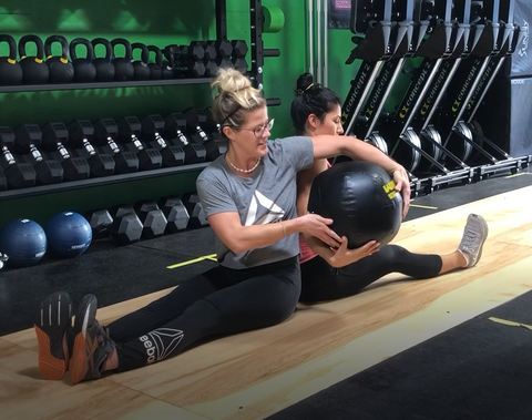 Coach Rachael Tibesar working one-on-one to warm-up a SoWal CrossFit® personal training client.