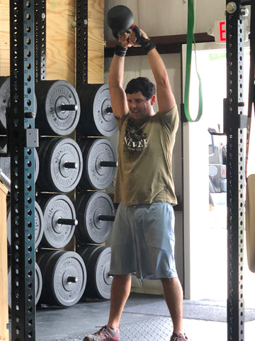 A SoWal CrossFit® athlete performing kettle bell swings in the gym