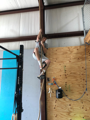 Teen Boy Performing A Rope Climb At SoWal CrossFit®