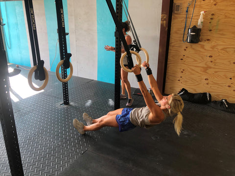 A SoWal CrossFit® athlete performing a body weight movement called a ring row. This is the type of exercise that you might find in The Burn programming.