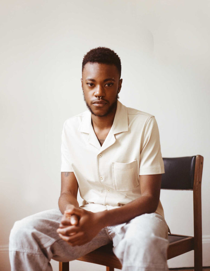 Black model in beige Francis button down shirt