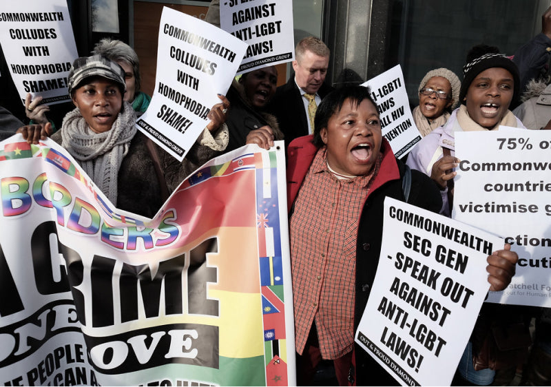 OutRAGE LGBTQ+ Advocacy Group Pride March with protesters holder slogan signs and pride flags