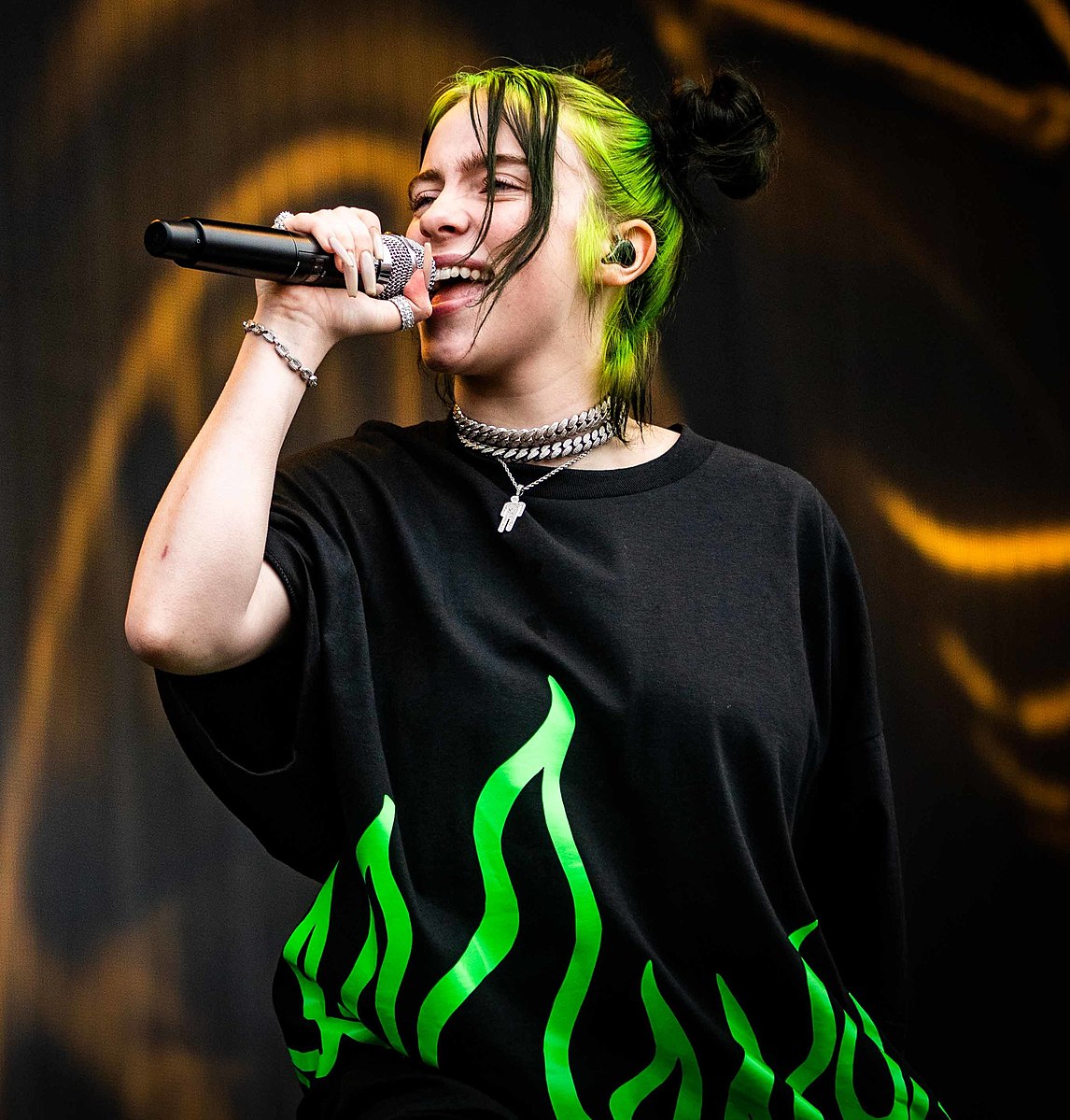 Billie Eilish in oversized black t-shirt with green flames