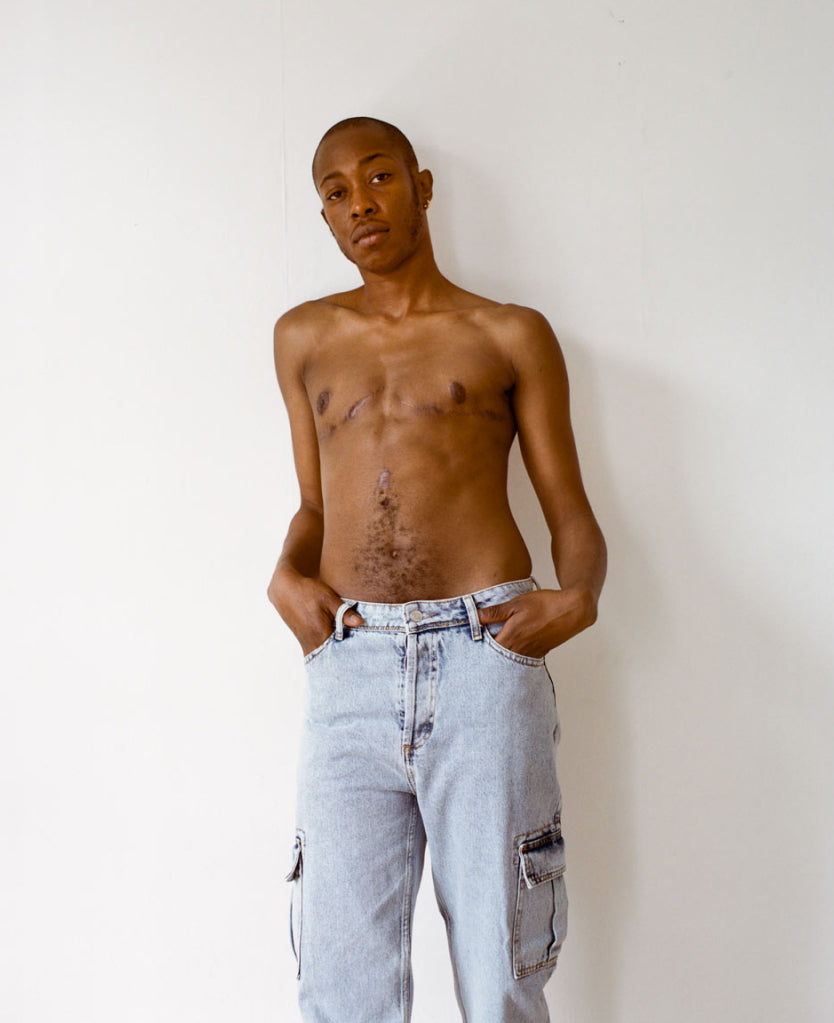 Trans model wearing light blue denim Jo jeans