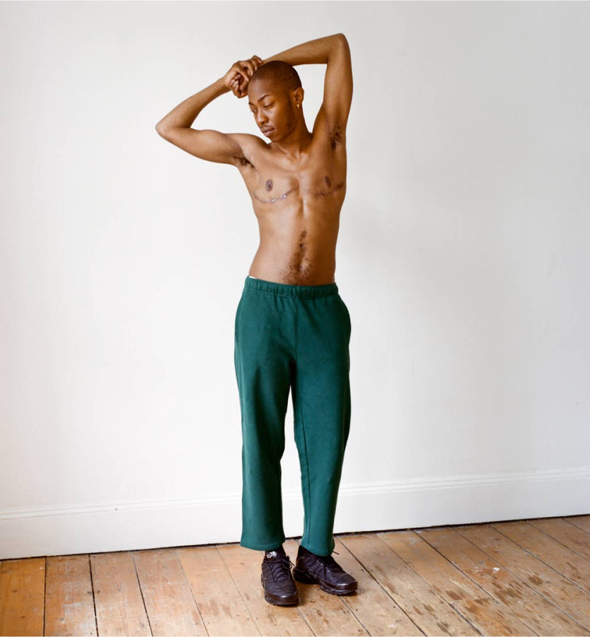 Shirtless model with forest green Jeremiah sweatpants