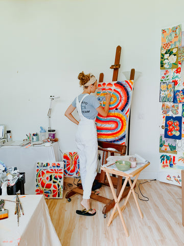 Artist Jordan McDowell in her art studio painting original fine art abstract paintings
