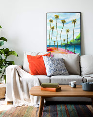 Large palm tree art print above a couch in a living room