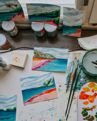 Tropical palm tree paintings on a desk