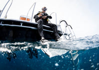 Diver sitting on a small boat