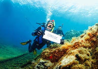 divers with underwater writing slate