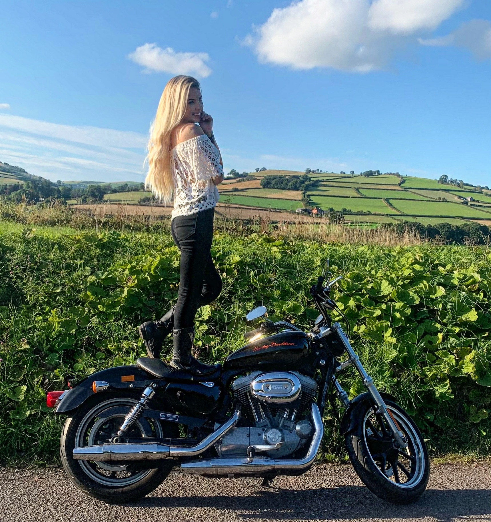 Lady Harley standing on her bike