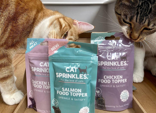 Cats sniffing catsprinkles packets
