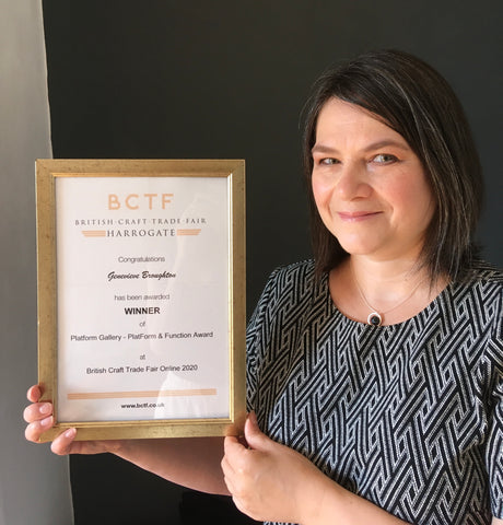 Genevieve Broughton holding award certificate