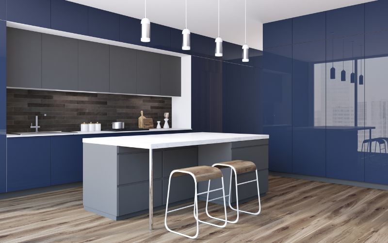 Navy blue kitchen with a bar