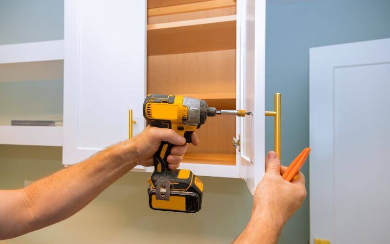 Re-attaching the handle to the cabinet door