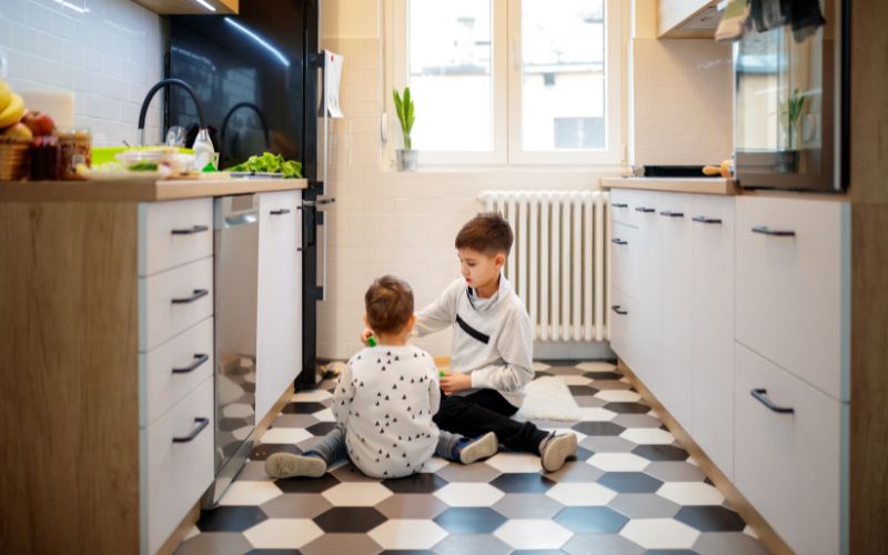 Siblings playing in the kitchen