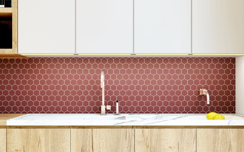 Stylish kitchen sink with Terracotta-colored backsplash